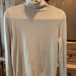 Gold colored turtleneck….